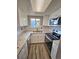 An updated kitchen boasts stainless steel appliances, granite counters and wood-style flooring at 10001 E Evans Ave # D, Aurora, CO 80247