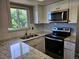 Updated kitchen features modern stainless steel appliances and a stylish granite countertop at 10001 E Evans Ave # D, Aurora, CO 80247