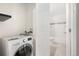 Modern laundry room adjacent to the bathroom, equipped with a front load washing machine at 10001 E Evans Ave # D, Aurora, CO 80247
