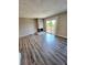 Living room boasting wood floors, a stone fireplace, and access to a balcony through sliding doors at 10001 E Evans Ave # D, Aurora, CO 80247