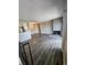 Open-concept living area featuring wood floors, a stone fireplace, and seamless flow to the kitchen at 10001 E Evans Ave # D, Aurora, CO 80247