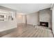 Spacious living room with stone fireplace and wood-look floors at 10001 E Evans Ave # D, Aurora, CO 80247