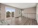 Open living room area with balcony access and staircase at 10001 E Evans Ave # D, Aurora, CO 80247
