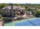 Expansive aerial view of a luxury home with a pool, tennis court, outdoor seating, and manicured grounds at 5650 E Stanford Dr, Cherry Hills Village, CO 80111