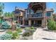 Beautiful backyard featuring landscaping, seating, fountains, and stone exterior at 5650 E Stanford Dr, Cherry Hills Village, CO 80111