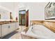 This luxurious bathroom features a soaking tub, granite countertops, and a modern vanity at 5650 E Stanford Dr, Cherry Hills Village, CO 80111