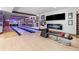 Basement bowling alley with modern fireplace, basketball art, and two lanes at 5650 E Stanford Dr, Cherry Hills Village, CO 80111