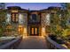 Stunning stone home with a beautiful walkway leading to an ornate double door entrance at 5650 E Stanford Dr, Cherry Hills Village, CO 80111