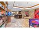 This recreation room is equipped with a bar, stone fireplace, and arcade games at 5650 E Stanford Dr, Cherry Hills Village, CO 80111