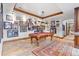 This billiards room features a vintage-style pool table and framed sports memorabilia on the walls at 5650 E Stanford Dr, Cherry Hills Village, CO 80111
