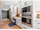 Convenient office nook with custom cabinets and countertop space located adjacent to a stainless steel oven and microwave at 5650 E Stanford Dr, Cherry Hills Village, CO 80111