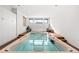 Indoor swimming pool, with natural lighting, storage, and wood deck surround at 5650 E Stanford Dr, Cherry Hills Village, CO 80111