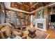 Elegant library featuring floor-to-ceiling bookshelves, a cozy seating area, and a fireplace, perfect for reading at 5650 E Stanford Dr, Cherry Hills Village, CO 80111