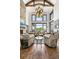 Bright living room boasts high ceilings, wood beams, and expansive windows showcasing the view at 5650 E Stanford Dr, Cherry Hills Village, CO 80111