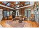 Living room with rich wood paneling, coffered ceilings, and detailed trim, creating a luxurious and inviting space at 5650 E Stanford Dr, Cherry Hills Village, CO 80111