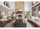 Grand living room with stone fireplace, high ceilings, and views of the upper balconies at 5650 E Stanford Dr, Cherry Hills Village, CO 80111