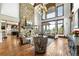 Bright living room featuring a stone fireplace, wood floors, and expansive windows at 5650 E Stanford Dr, Cherry Hills Village, CO 80111