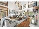 Open concept living room with wood floors, high ceilings, stone accents, and natural light at 5650 E Stanford Dr, Cherry Hills Village, CO 80111