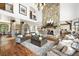 Spacious living room with stone fireplace, wood floors, and open layout to kitchen at 5650 E Stanford Dr, Cherry Hills Village, CO 80111