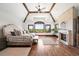 Spacious primary bedroom with beamed ceilings, a stone fireplace, and a large window providing scenic views at 5650 E Stanford Dr, Cherry Hills Village, CO 80111