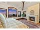 This main bedroom features a cozy fireplace and large windows showcasing scenic mountain views at 5650 E Stanford Dr, Cherry Hills Village, CO 80111