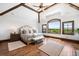 This main bedroom boasts vaulted ceilings with exposed beams and oversized windows with views at 5650 E Stanford Dr, Cherry Hills Village, CO 80111