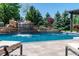 This gorgeous pool features a rock waterfall, lush landscaping, and lounge chairs for ultimate relaxation at 5650 E Stanford Dr, Cherry Hills Village, CO 80111