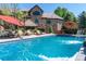The beautiful pool features a waterfall with an outdoor lounging area and an attractive stone home at 5650 E Stanford Dr, Cherry Hills Village, CO 80111