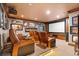 The luxurious theater room has leather recliners, a big screen, and decoratively framed artwork at 5650 E Stanford Dr, Cherry Hills Village, CO 80111