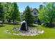 Stunning water feature with natural stone and lush landscaping in a beautifully maintained yard at 5650 E Stanford Dr, Cherry Hills Village, CO 80111
