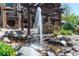 Beautiful water feature with a stone fountain and manicured landscaping in an inviting outdoor area at 5650 E Stanford Dr, Cherry Hills Village, CO 80111