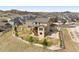 Aerial view of the tan home featuring a spacious fenced yard with a wooden deck and walkout basement at 5998 Berry Ridge Way, Castle Rock, CO 80104