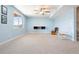 Spacious basement featuring neutral carpeting, a large window, ceiling fan, and two rocking chairs at 5998 Berry Ridge Way, Castle Rock, CO 80104