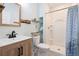Modern bathroom featuring a single sink vanity with wood cabinets and a walk-in shower at 5998 Berry Ridge Way, Castle Rock, CO 80104