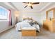 Sunlit bedroom featuring comfortable furniture, large window with scenic views, and tray ceilings at 5998 Berry Ridge Way, Castle Rock, CO 80104
