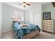 Comfortable bedroom featuring a double bed with blue patterned bedding and a chest of drawers at 5998 Berry Ridge Way, Castle Rock, CO 80104