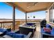 Outdoor deck features a covered seating area with comfortable furniture and neighborhood views at 5998 Berry Ridge Way, Castle Rock, CO 80104