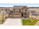 Beautiful two-story home with well-manicured lawn and three car garage in Gathering-friendly neighborhood at 5998 Berry Ridge Way, Castle Rock, CO 80104
