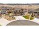 Areal view of two-story home featuring a three car garage, landscaped yard, and neighborhood views at 5998 Berry Ridge Way, Castle Rock, CO 80104