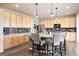 Bright kitchen features stainless steel appliances, granite countertops, wooden cabinets, a large island, and hardwood floors at 5998 Berry Ridge Way, Castle Rock, CO 80104