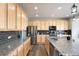 Bright kitchen with stainless steel appliances, granite counters, and plenty of cabinet space at 5998 Berry Ridge Way, Castle Rock, CO 80104