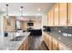 Modern kitchen with a granite countertop island and stainless steel sink at 5998 Berry Ridge Way, Castle Rock, CO 80104