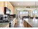 Open-concept kitchen flows into the dining room with stainless steel appliances and dark backsplash at 5998 Berry Ridge Way, Castle Rock, CO 80104