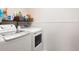 Convenient laundry room with modern washer and dryer units and shelving for storage at 5998 Berry Ridge Way, Castle Rock, CO 80104