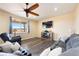 Bright living room features a modern ceiling fan, nice furniture, and a large window at 5998 Berry Ridge Way, Castle Rock, CO 80104