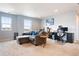 Inviting living room showcasing a sectional sofa, natural light, and a comfortable work space at 5998 Berry Ridge Way, Castle Rock, CO 80104