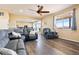 Spacious living room with hardwood floors flows into the open-plan kitchen and dining area at 5998 Berry Ridge Way, Castle Rock, CO 80104