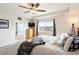 Comfortable main bedroom featuring an ensuite bathroom, tray ceiling, and ample natural light at 5998 Berry Ridge Way, Castle Rock, CO 80104