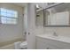 Bright bathroom with subway tile shower, white vanity, and window at 10359 W Fair Ave # F, Littleton, CO 80127
