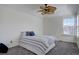 Spacious bedroom featuring a ceiling fan and a large window with natural light at 10359 W Fair Ave # F, Littleton, CO 80127